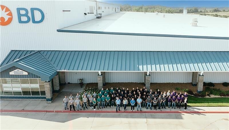 An aerial shot of BD staff standing in front of their facility.