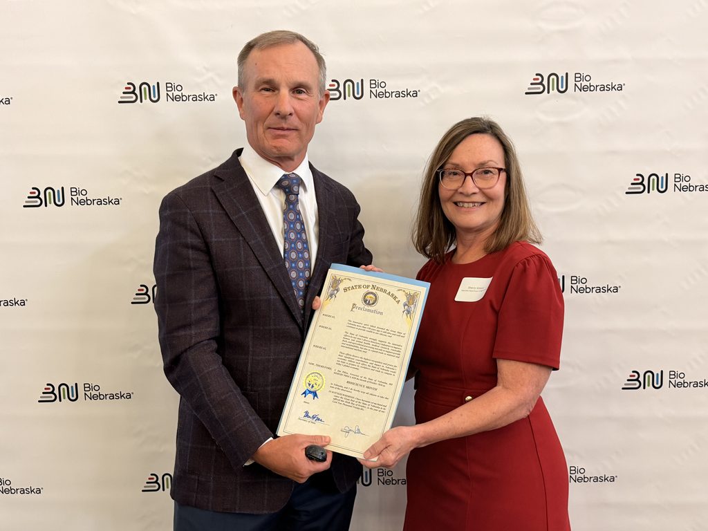 Bio Nebraska Executive Director Rob Owen and Nebraska Department of Agriculture Director Sherry Vinton hold Governor Pillen's proclamation for Bioscience Month in Nebraska.
